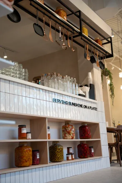 "Serving Sunshine on a Plate" tile counter with house-made preserves at Eggstatic Oakville