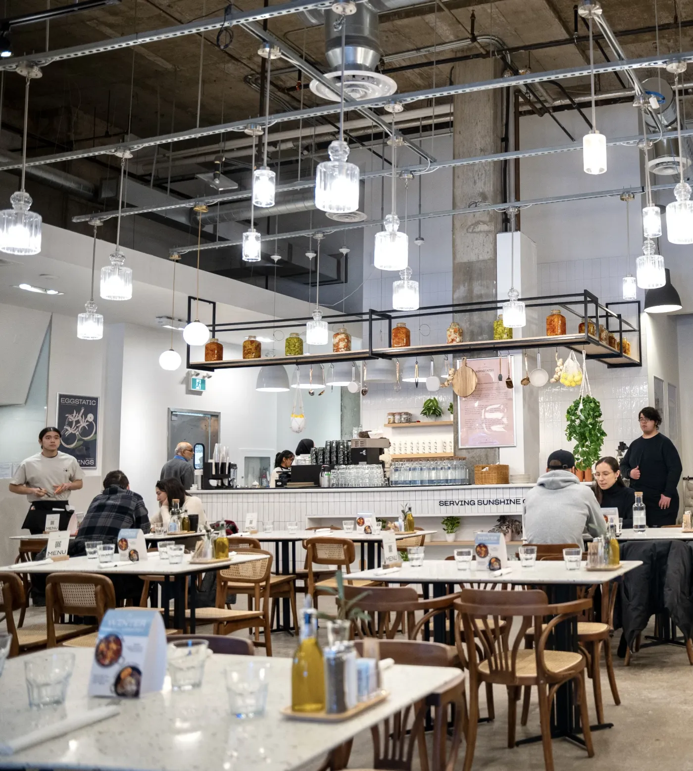 Eggstatic Downtown Toronto dining room interior with open kitchen and pendant lighting on Bloor Street East