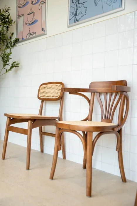 Bentwood chairs against tiled wall with coffee illustrations at Eggstatic London Ontario
