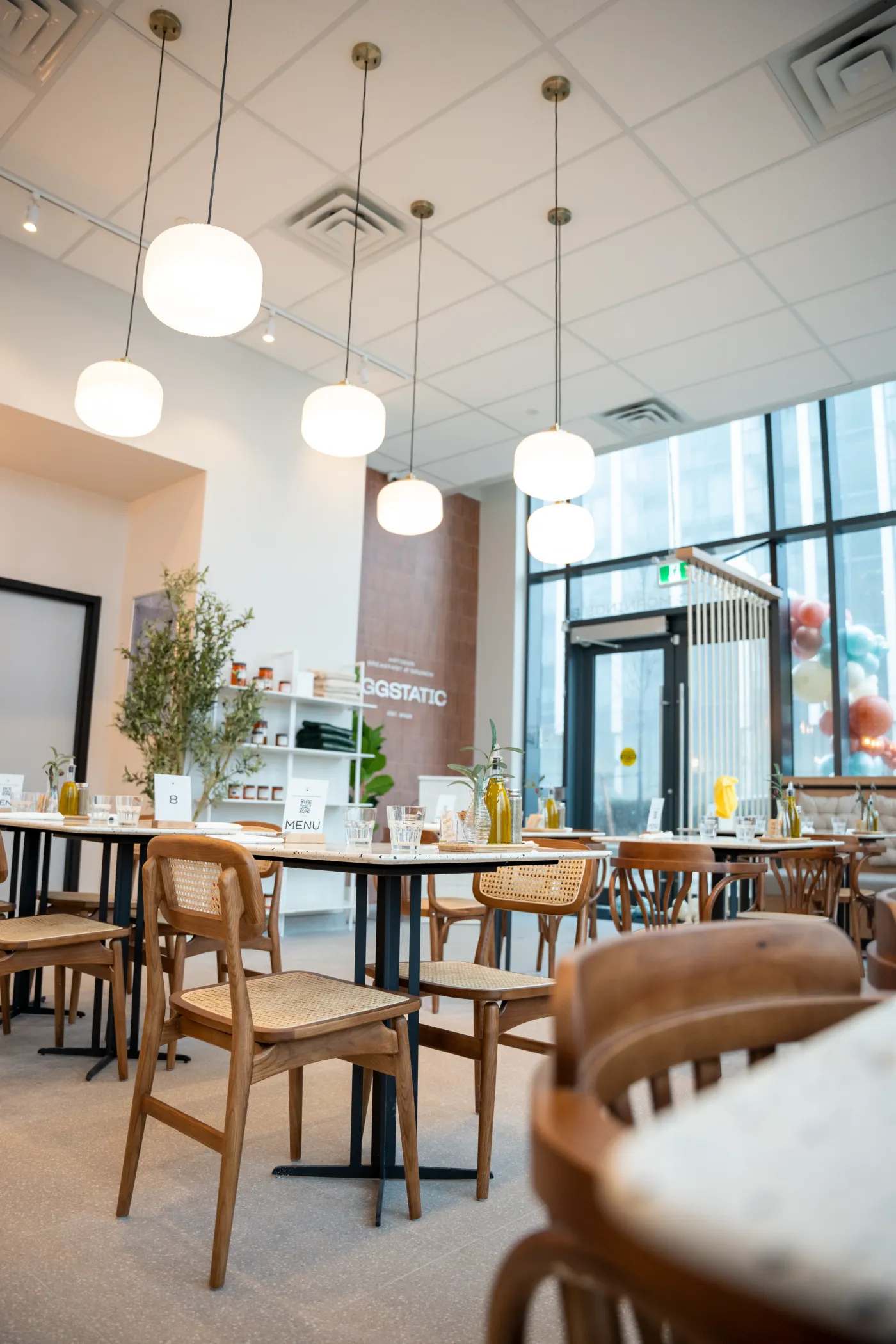 Eggstatic dining room with globe pendant lights and cane chairs by the windows