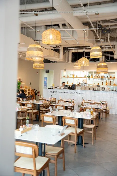 Eggstatic Scarborough dining room with rattan pendants and the "Serving Sunshine on a Plate" counter