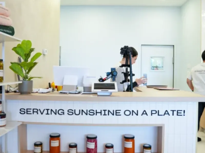 Pickup counter with "Serving Sunshine on a Plate" tagline and preserves at Eggstatic Waterdown