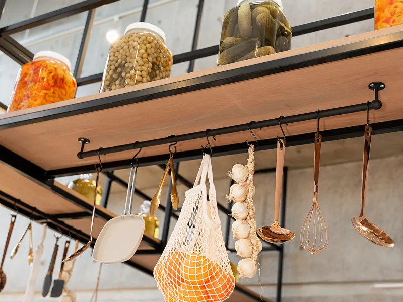 Eggstatic overhead shelf with preserve jars and hanging utensils
