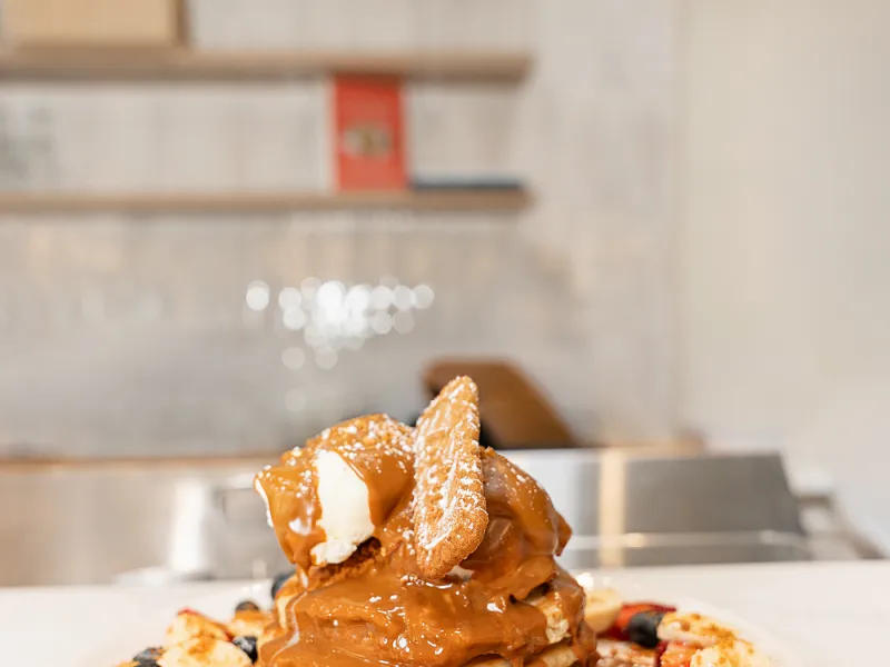 Lotus Biscoff pancake stack with banana and berries at Eggstatic
